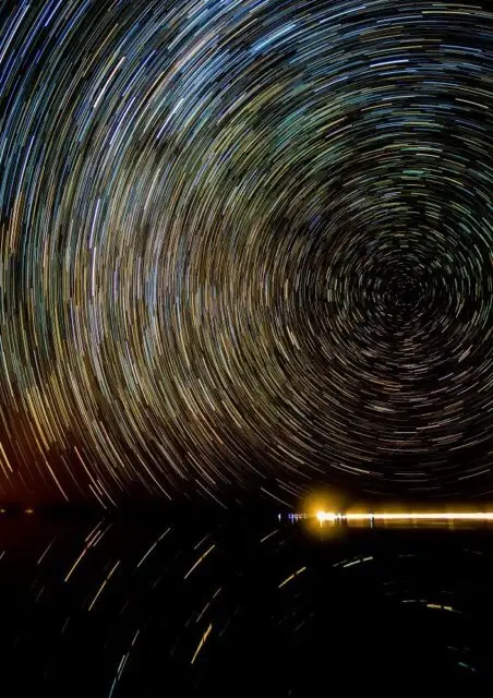 夜のウユニ塩湖に広がる、星の軌跡が描く光の渦