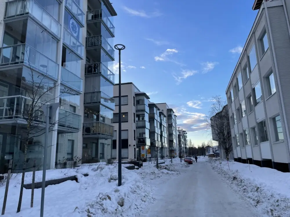 雪の街路と並ぶガラス張りの集合住宅